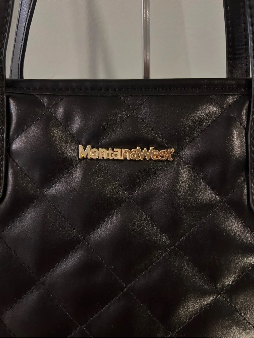 Montana West Black Quilted Tote interior zippered pocket and two slip pouches